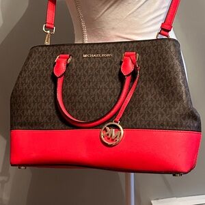 Brand new bag never used. Michael Kors brown and red 3 pocket purse.
